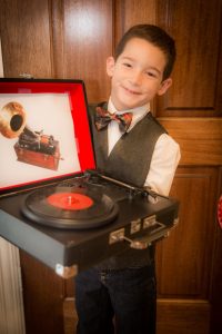 Here's my little Thomas Edison heading off to school with his portable Crosley "phonograph" for his presentation prop.