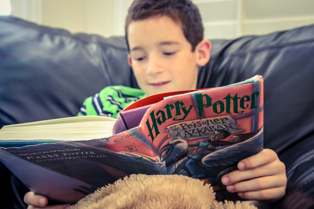 Here he is...captured again by the Harry Potter series! Just like his mom! I just wish he wanted me to read it aloud to him...